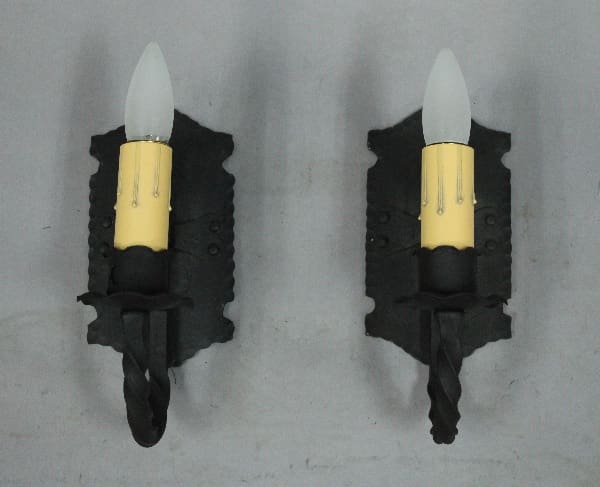 Two decorative wall-mounted candle holders.