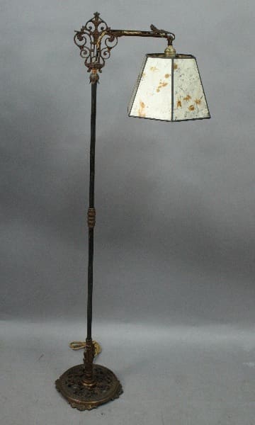 14867. Spanish Revival Bridge lamp with new mica shade with intricate metalwork and a stained glass lampshade, standing against a gray background.