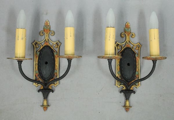 Wall sconces with ornate candle holders.