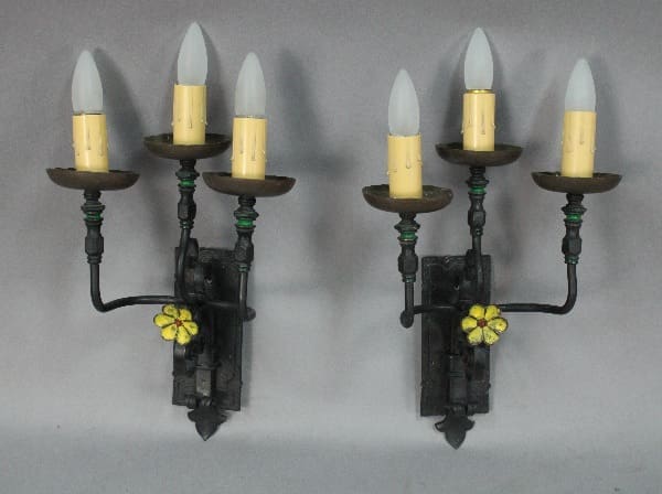 Vintage wall sconces with three candle holders.
