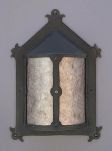 Decorative wall lantern with a glass cover.