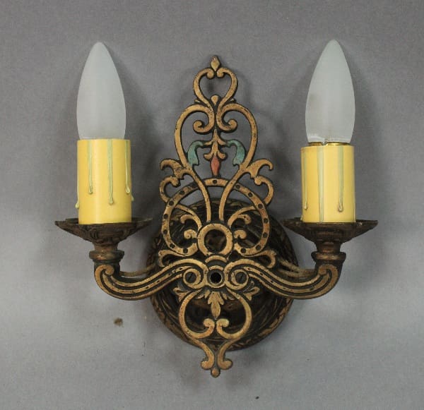 Ornate wall sconce with two light bulbs.