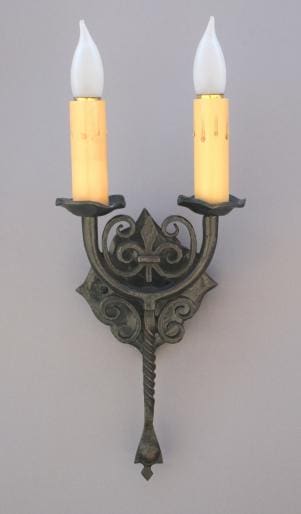Antique-style wall sconce with two candles.