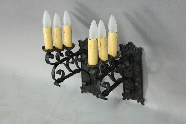 Wall-mounted candle holder with six lights.