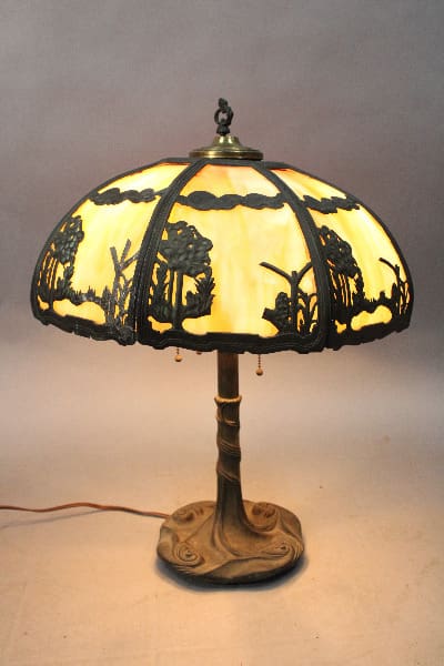 Circa 1920's Table Slag Glass Lamp With Beautiful Shade And Base with a nature-inspired design, illuminated and displayed against a neutral background.