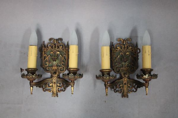 Ornate vintage wall sconces with candles.