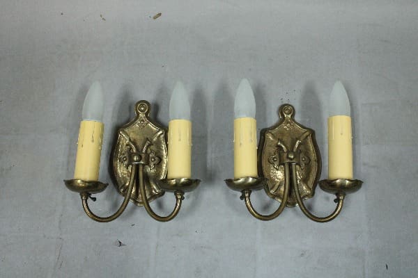 Bronze wall sconces with candle lights.