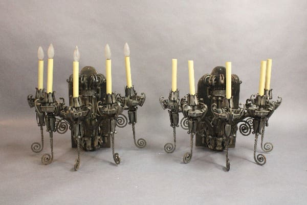 Candle holders with yellow candles and ornate design.