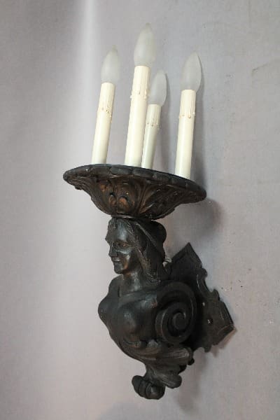 Bronze wall sconce with four candle holders.