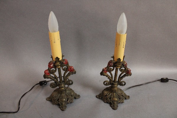 Two 15117. Pair of 1920's Lamps With Polychrome Finish designed to resemble candles, each with ornate floral brass bases, displayed against a gray background.