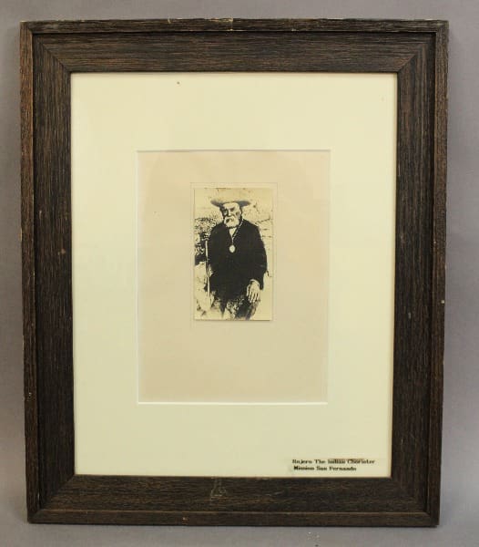 Framed black-and-white portrait of an elderly man.