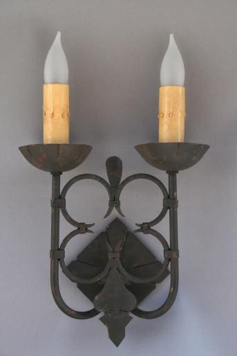 Wall-mounted candle holder with two lights.
