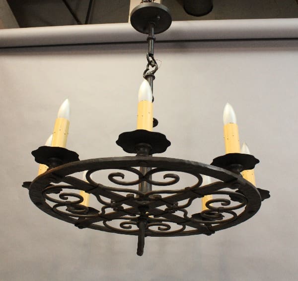 Decorative wrought iron chandelier with candles.