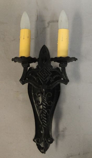 Black wall sconce with two candle lights.