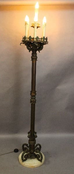 Antique floor-standing 15219. Imposing Tall 1920's Torchiere with three lit electric candles, featuring ornate metalwork, set against a neutral backdrop.