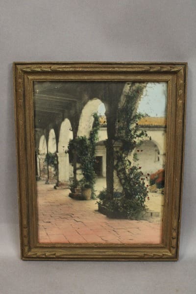 Framed image of a colonnade with plants.