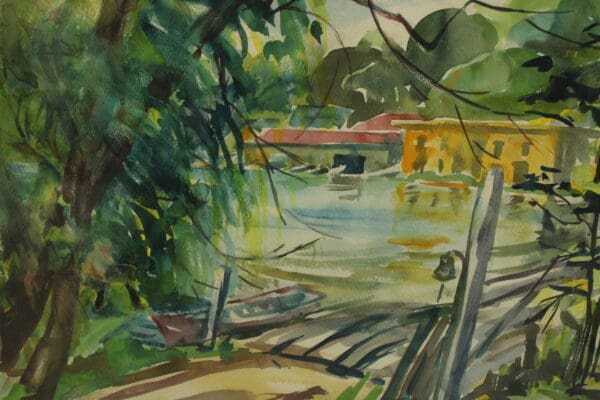 Lush landscape with water and boats.