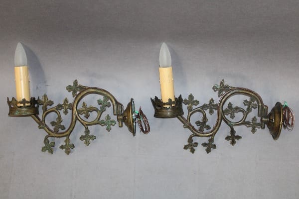 Vintage brass wall sconces with candle holders.