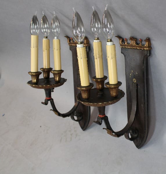 Wall-mounted antique candle holder with bulbs.