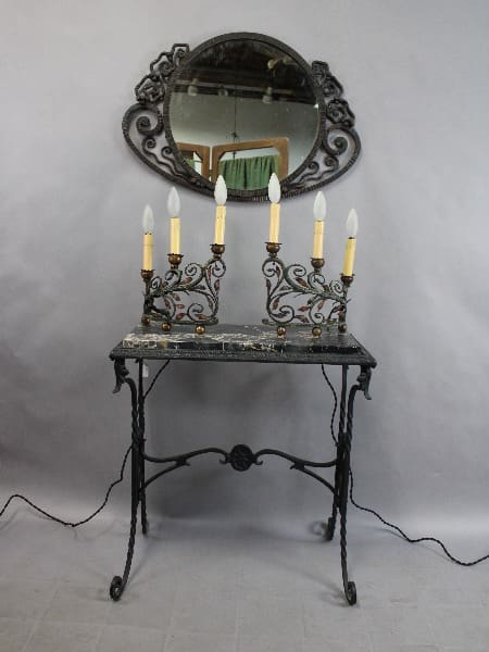 Vintage 15298. Rare pair of 1920's Wrought Iron Table Lamps with an ornate mirror and candelabra, featuring intricate designs and a marble top, set against a simple gray backdrop.