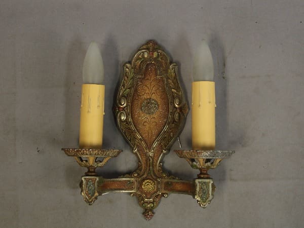 Antique wall sconce with two candles.