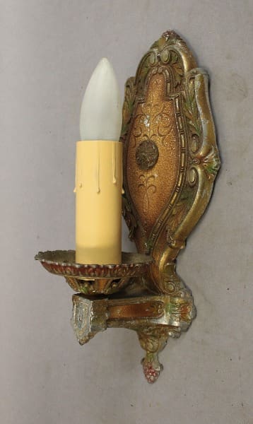 Vintage wall sconce with candle holder.
