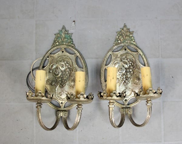 Vintage wall sconces with candle holders.