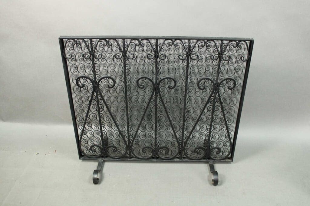 A 14426. Lovely Spanish Revival Firescreen with intricate scroll designs, set against a grey background.