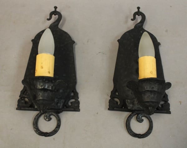 Two vintage wall sconces with candles.