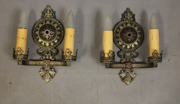 Ornate vintage wall sconces with candles.