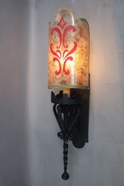 Decorative wall sconce with glowing shade.