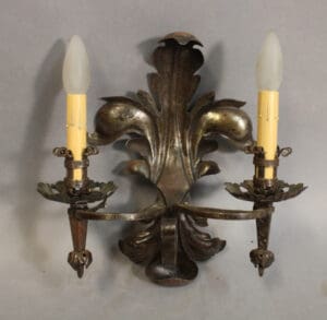 Vintage wall sconce with two candle holders.