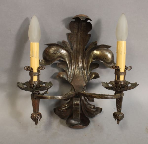 Vintage wall sconce with two candle holders.