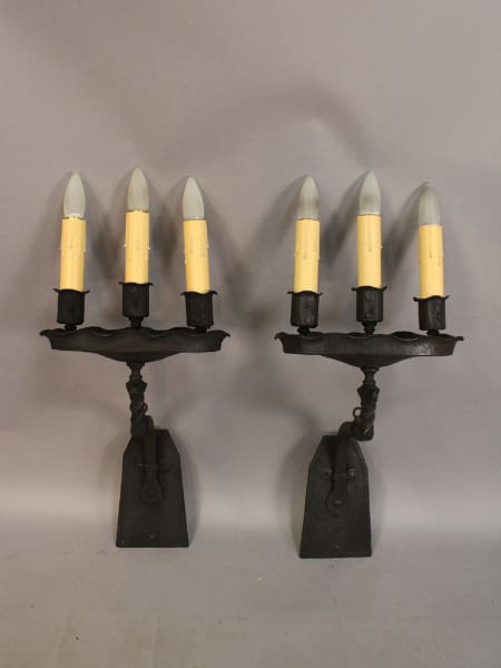 Two candle holders with four faux candles.