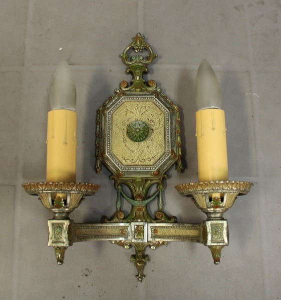 Vintage wall sconce with two candle holders.