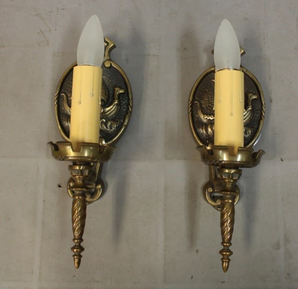 Brass wall sconces with faux candles.