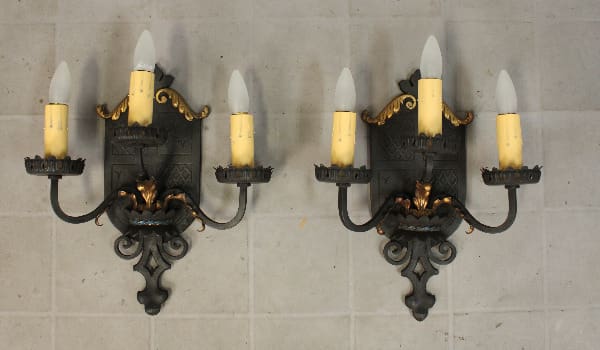 Wall sconces with candles, decorative design.