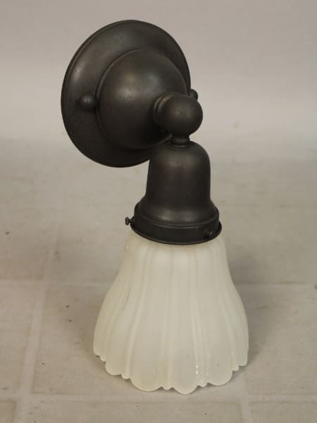 Vintage wall light fixture with frosted glass.