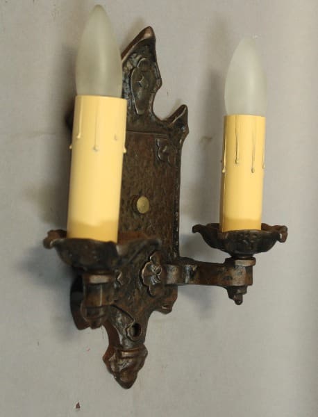 Vintage wall sconce with yellow candle bulbs.