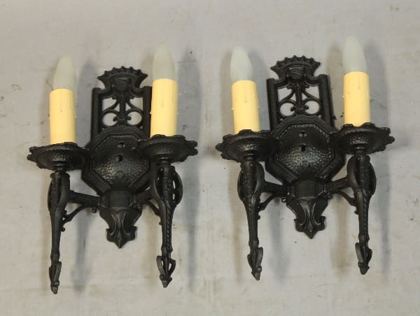 Vintage black wall sconces with light bulbs.