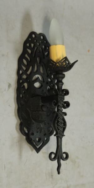 Black wall sconce with decorative design.