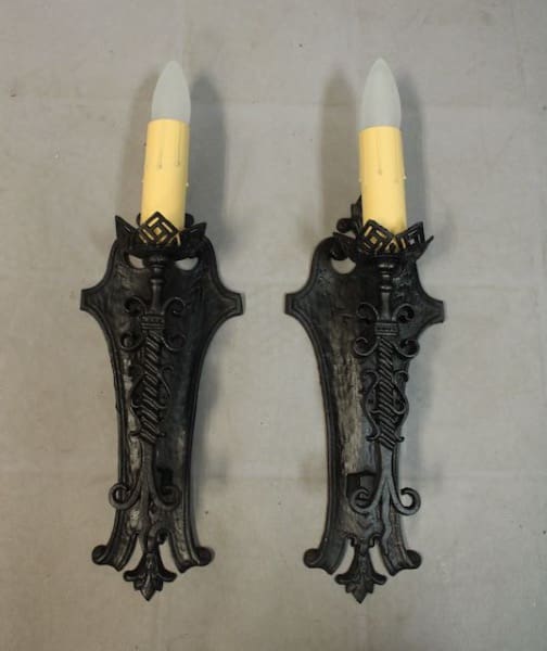 Antique wall sconces with yellow candles.