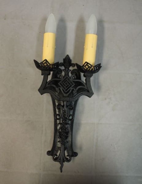 Black wall sconce with two fake candles.