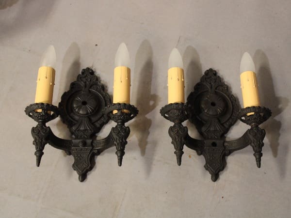 Vintage black sconces with yellow candles.