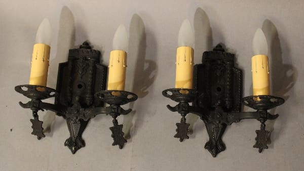 Two decorative wall sconces with candles.