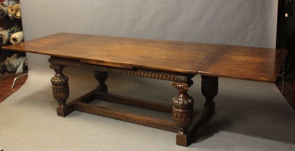 16354. Large Scale 1920's Table Opens to 10 Feet with ornate, carved legs and a stretcher base, set against a neutral backdrop.