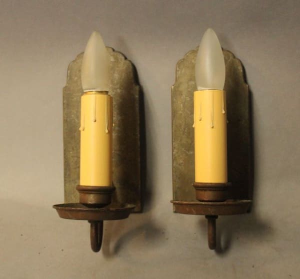 Vintage wall sconces with yellow candle bulbs.