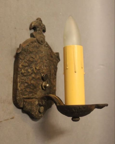 Vintage wall lamp with yellow candle design.