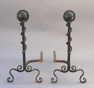 2583. Pair of Iron Andirons with spiral designs and globular tops on a neutral background.