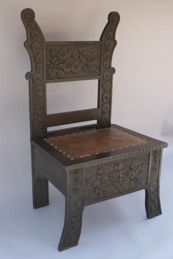 3316. Carved Arts And Crafts Side Chair with ornate floral carvings on the backrest and legs, featuring a worn seat, against a plain background.